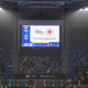 A message asking for donations for the Red Cross is displayed on a screen while fans sit in the haze created by the Australian bushfires at a tennis match in Sydney on January 4, 2020